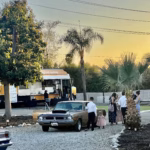 Vintage Cars at King Street Orchard

The sight of vintage cars parked beneath the citrus trees at King Street Orchard in Redlands, California, is nothing short of timeless. Gleaming chrome and classic curves glisten in the sunlight as each car reflects a piece of history against the orchard’s natural backdrop. The 1906 farmhouse, surrounded by avocado and orange trees, adds to the nostalgic charm—creating a scene that feels straight out of a golden-era postcard.

Guests stroll the farmhouse deck and grassy lawn, admiring each automobile’s craftsmanship while enjoying the gentle scent of orange blossoms carried on the breeze. From sleek convertibles to restored classics, every vehicle tells a story, and together they bring an air of sophistication and style to the orchard’s relaxed setting.

Whether featured as part of a wedding entrance, photo shoot, or vintage car show, these classics perfectly complement King Street Orchard’s rustic elegance. As the sun sets, the warm golden light dances off polished hoods, and photographers capture moments that feel both cinematic and heartfelt.

At King Street Orchard, the beauty of vintage cars blends effortlessly with the serenity of nature—celebrating history, craftsmanship, and the timeless joy of gathering in a place where every detail feels artfully preserved.