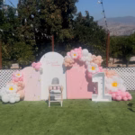 A Beautiful First Birthday at King Street Orchard

A child’s first birthday at King Street Orchard in Redlands, California, is a celebration filled with beauty, laughter, and love. The orchard’s open-air charm creates the perfect setting for family and friends to gather beneath the citrus trees, surrounded by fresh blooms and sunshine. The spacious farmhouse deck and lush green lawn provide plenty of room for children to play, guests to mingle, and memories to unfold.

Tables are decorated with soft pastels, balloons sway in the breeze, and a dessert table glows with a single candle waiting to be blown out. Laughter fills the air as guests enjoy refreshments, music, and the simple joy of being together outdoors. Parents capture every moment—the baby’s first taste of cake, the happy squeals of cousins running through the grass, and the golden light that warms the orchard at sunset.

As the day turns to evening, string lights twinkle above, creating a magical glow that feels both peaceful and festive. King Street Orchard offers a backdrop that blends nature’s beauty with heartfelt celebration—a place where one-year milestones become timeless memories surrounded by love, laughter, and the gentle spirit of the orchard.