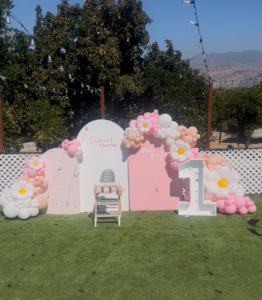 A Beautiful First Birthday at King Street Orchard

A child’s first birthday at King Street Orchard in Redlands, California, is a celebration filled with beauty, laughter, and love. The orchard’s open-air charm creates the perfect setting for family and friends to gather beneath the citrus trees, surrounded by fresh blooms and sunshine. The spacious farmhouse deck and lush green lawn provide plenty of room for children to play, guests to mingle, and memories to unfold.

Tables are decorated with soft pastels, balloons sway in the breeze, and a dessert table glows with a single candle waiting to be blown out. Laughter fills the air as guests enjoy refreshments, music, and the simple joy of being together outdoors. Parents capture every moment—the baby’s first taste of cake, the happy squeals of cousins running through the grass, and the golden light that warms the orchard at sunset.

As the day turns to evening, string lights twinkle above, creating a magical glow that feels both peaceful and festive. King Street Orchard offers a backdrop that blends nature’s beauty with heartfelt celebration—a place where one-year milestones become timeless memories surrounded by love, laughter, and the gentle spirit of the orchard.