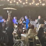 A beautiful anniversary party at **King Street Orchard** in **Redlands** unfolds like a dream beneath the glow of the setting sun. The historic 1906 farmhouse stands gracefully among rows of citrus and avocado trees, its charm complemented by the scent of fresh blossoms and the soft rustle of orchard leaves. Guests are greeted with the warmth of string lights and gentle music drifting through the air as they gather on the **spacious 800-square-foot deck** overlooking the orchard.

Tables are elegantly arranged with crisp linens, flickering candles, and floral centerpieces that reflect the couple’s favorite colors. The celebration flows naturally between laughter, toasts, and shared memories, as friends and family mingle under the stars. The **3,000-square-foot grassy area** becomes a lively dance floor, surrounded by nature’s beauty and twinkling lights.

A buffet of locally inspired cuisine and hand-crafted desserts adds to the sense of community and joy. Guests enjoy the comfort of **ADA-compliant restrooms** and thoughtful touches like heaters and misters that ensure everyone feels relaxed and at home.

As evening deepens, the orchard glows with romance — a blend of rustic charm and timeless elegance. The couple’s love story is celebrated not just in words, but in every detail: the laughter of family, the clinking of glasses, and the golden California twilight. King Street Orchard provides the perfect setting — intimate, natural, and unforgettable — for an anniversary party that honors the past while celebrating a future filled with love.
