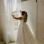 The bride is in the King Street Orchard wedding suite and is admiring the citrus grove,